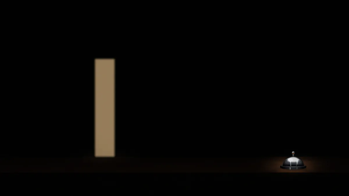 An empty dark lobby, a lit doorway, and one bell on the desk